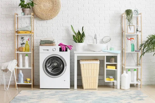 Stack of clean clothes on washing machine in laundry room