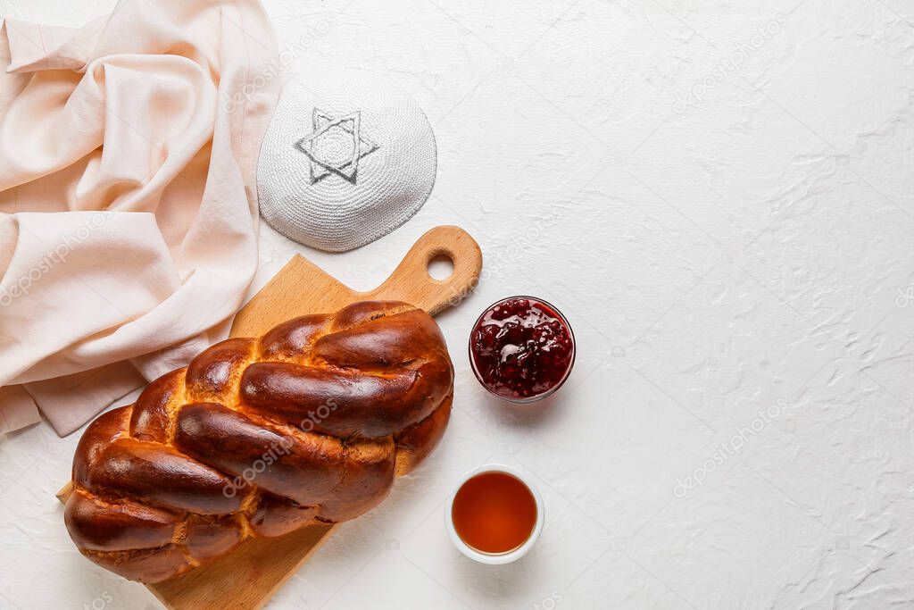 Traditional challah bread with Jewish cap on white background. Shabbat Shalom