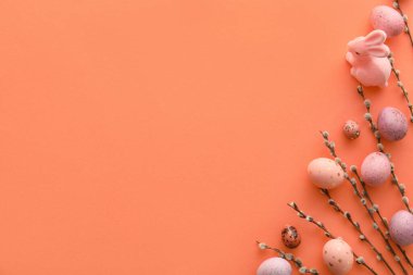 Beautiful Easter eggs, bunny and pussy willow branches on color background