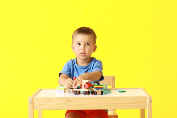 Cute Little Boy Playing Building Blocks Table Yellow Background — Stock Photo, Image