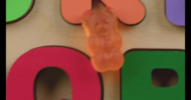 Wooden Board Letters Yummy Jelly Bears Closeup Royalty Free Stock Video