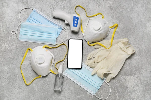 Medical Masks Digital Thermometer Gloves Mobile Phone Grunge Background — Stock Photo, Image