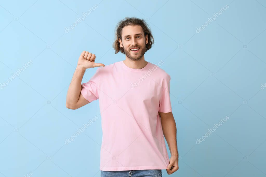 Handsome young man in stylish t-shirt on blue background