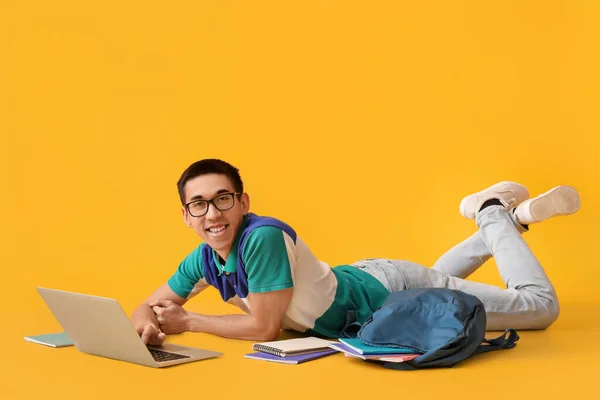 Male Asian Student Using Laptop Yellow Background — Stock Photo, Image