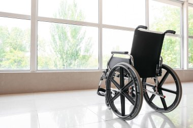 Modern wheelchair in empty room clipart