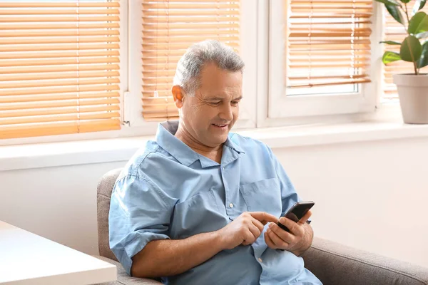 Senior Man Met Behulp Van Mobiele Telefoon Fauteuil Thuis — Stockfoto