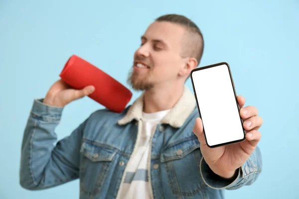 Man Holding Mobile Phone Wireless Portable Speaker Blue Background — Stock Photo, Image