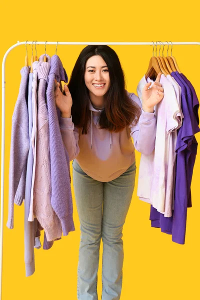Young Asian Woman Rack Clothes Purple Shades Yellow Background — Stock Photo, Image