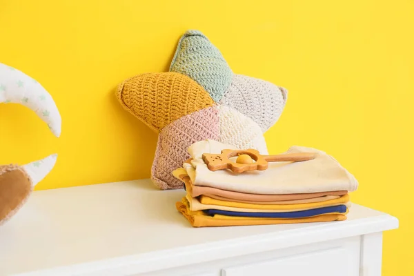 Stack Baby Clothes Toys Table Yellow Wall — Stock Photo, Image