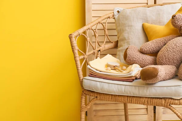 Armchair Baby Clothes Toys Yellow Wall — Stock Photo, Image