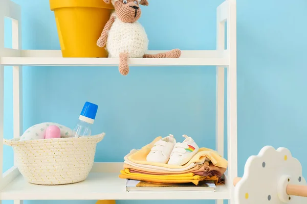 Shelving Unit Baby Clothes Bottles Toys Blue Wall — Stock Photo, Image