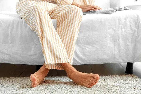 Young Barefooted Man Reading Magazine Bedroom — Stock Photo, Image