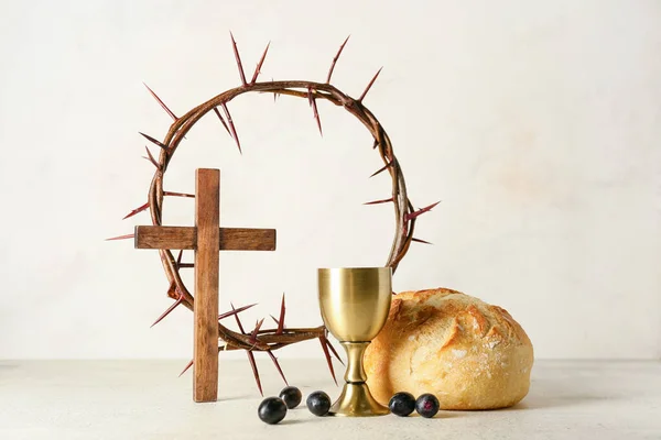 パンとクロスと光の背景にとげの冠を持つワインのカップ — ストック写真