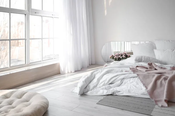 房间内部白墙附近舒适的床和海棠花 — 图库照片