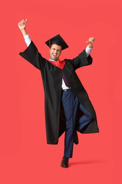 Young Male Graduate Dancing Red Background — Stock Photo, Image
