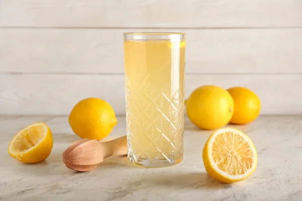 stock image Glass of lemon juice on table