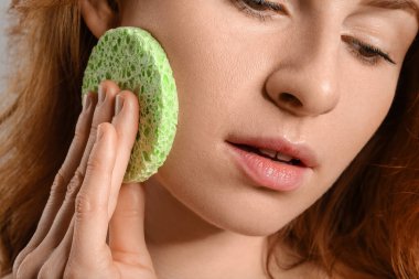 Makyaj süngeri olan güzel kadın, yakın plan.