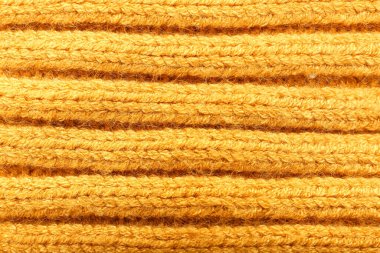 Sarı örgü elbiselerin dokusu, yakın plan.