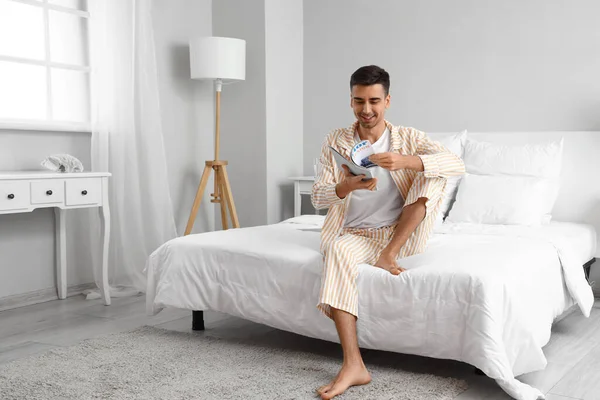 Young Barefooted Man Reading Magazine Bedroom — Stock Photo, Image