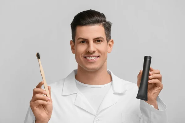 Handsome Young Man Activated Charcoal Tooth Paste Brush Light Background — Stock Photo, Image