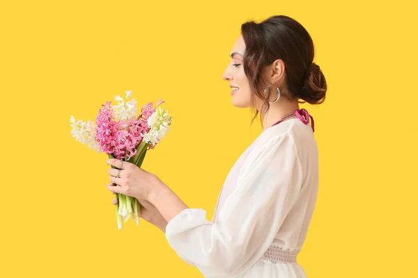 Sarı Arka Planda Sümbül Çiçekleri Olan Güzel Genç Bir Kadın — Stok fotoğraf