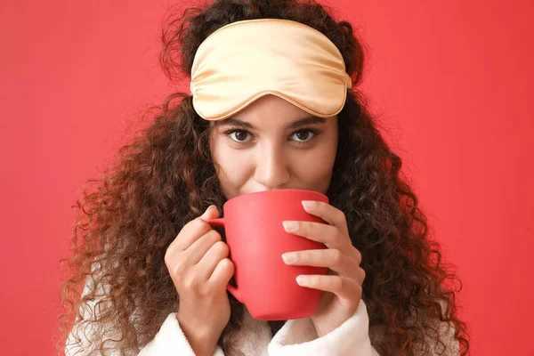 Young African American Woman Sleeping Mask Drinking Coffee Red Background — Stock Photo, Image