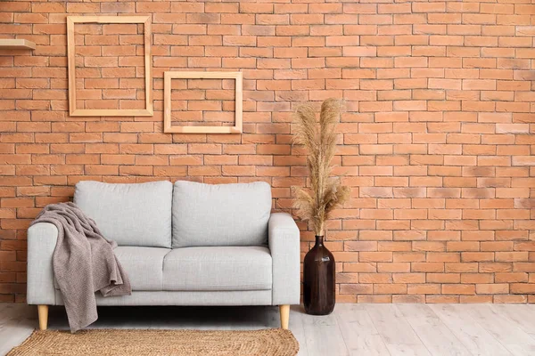 Comfortable Sofa Vase Pampas Grass Brick Wall — Stock Photo, Image