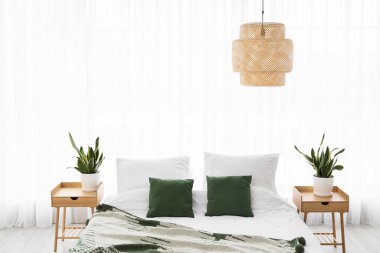 Rahat yatak, komodinlerin ve oda bitkilerinin olduğu yer.