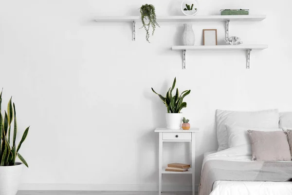 Comfortable Bed Nightstand Houseplants White Wall — Stock Photo, Image