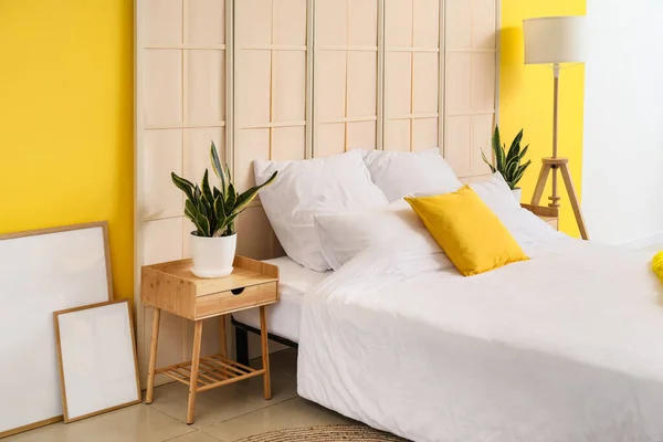 Comfortable Bed Houseplants Nightstand Blank Posters Yellow Wall — Stock Photo, Image
