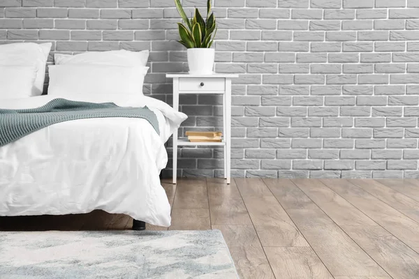 Comfortable Bed Houseplant Nightstand Grey Brick Wall — Stock Photo, Image