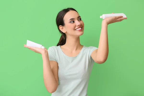 Young Woman Tubes Toothpaste Green Background — ストック写真
