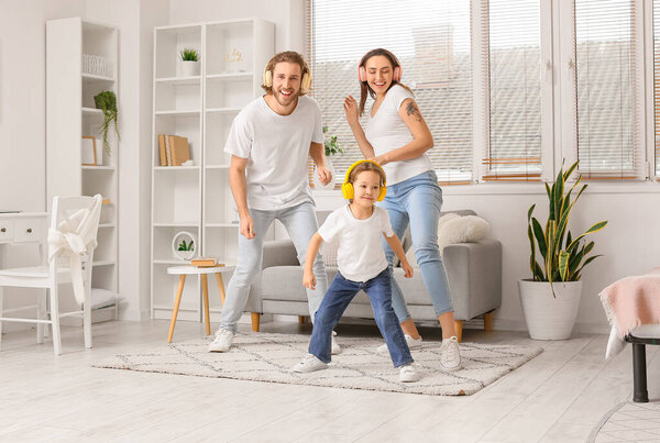 Happy young family listening to music at home