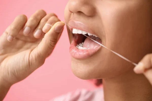 African American Teenage Girl Flossing Teeth Pink Background Closeup — Stock Photo, Image