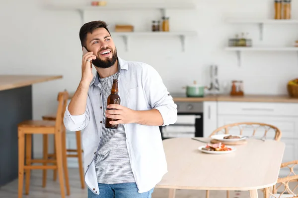 Handsome Bearded Man Bottle Beer Talking Mobile Phone Kitchen — Stock Photo, Image