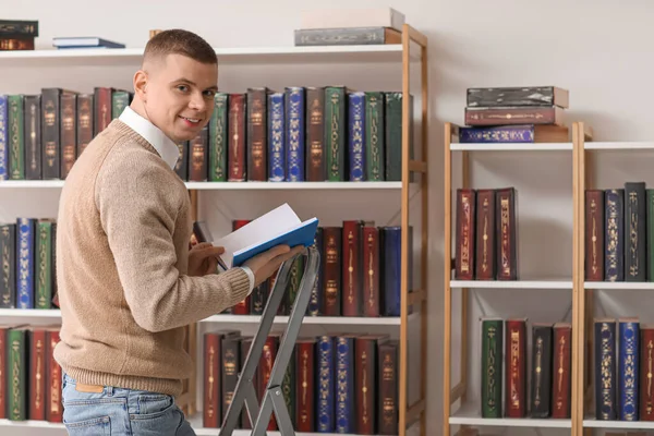 Студент Мужчина Возле Книжных Полок Библиотеке — стоковое фото