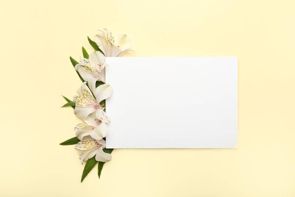 Composition with blank sheet of paper and alstroemeria flowers on color background