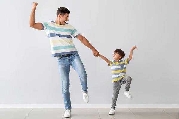 Happy Dancing Man His Son Light Background — Stock Photo, Image