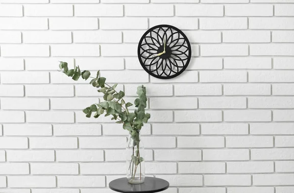Vase Eucalyptus Branches Modern Clock Hanging Light Brick Wall Room — Stock Photo, Image
