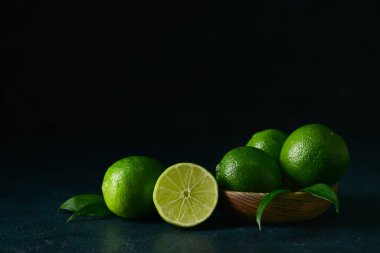 Koyu arkaplanda bir kase taze olgun limon