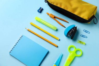 Mavi arkaplanda okul kırtasiyesi olan kalem kutusu