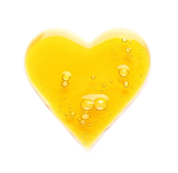 Krople Żółtego Serum Kosmetycznego Kształcie Serca Wyizolowane Białym — Zdjęcie stockowe