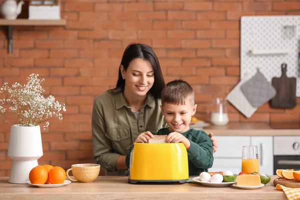 Little Boy His Mother Putting Bread Slices Toaster Kitchen — Stock Photo, Image