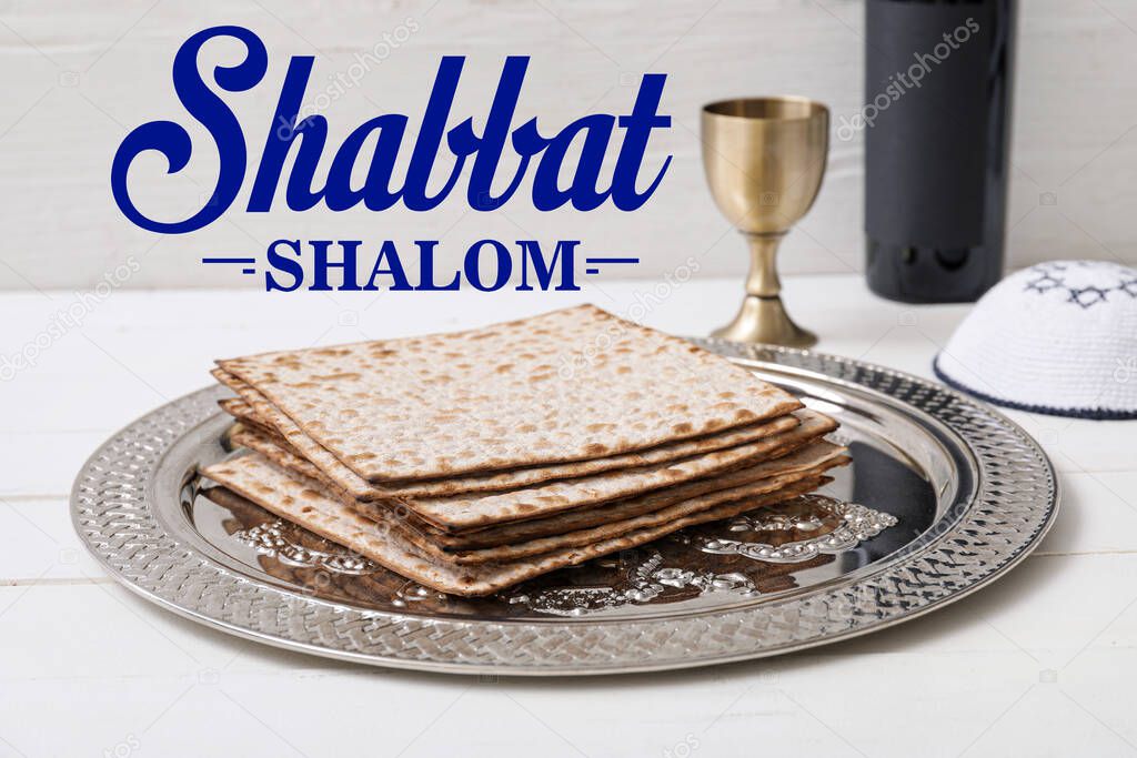 Plate with matza and chalice of wine on table. Shabbat Shalom