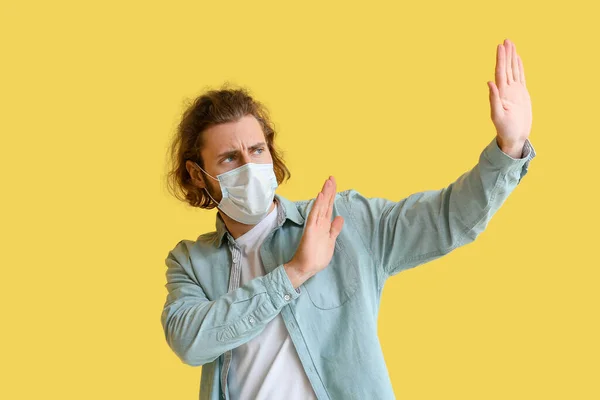 Young Man Medical Mask Avoiding Something Yellow Background — ストック写真