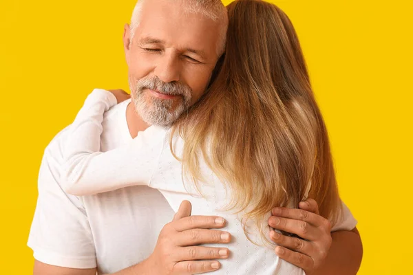 Senior Man Hugging His Little Granddaughter Yellow Background — Stock Photo, Image