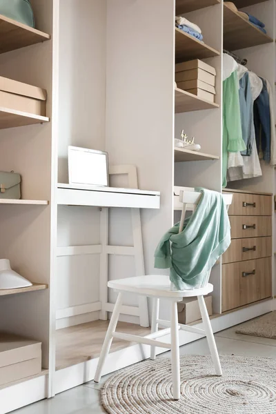 Modern gardıropta dizüstü bilgisayarı olan rahat bir iş yeri.