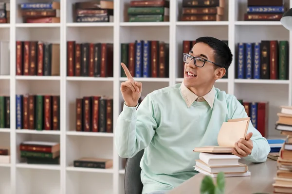 Estudiante Asiático Con Libros Apuntando Algo Biblioteca —  Fotos de Stock