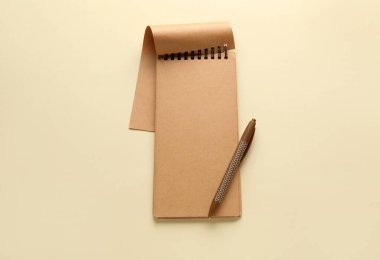 Açık renk arkaplan, üst görünüm üzerine defter ve kalem