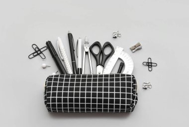 Açık arkaplanda okul kırtasiyesi olan kalem kutusu, üst görünüm